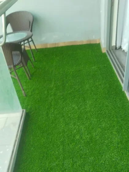 Another angle of the Noida balcony, showing the neat installation of the artificial grass.