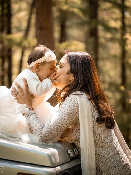 A candid moment of love between a mother and her one-year-old daughter during an outdoor shoot. These unposed, emotional interactions are what make a family photography session truly special.