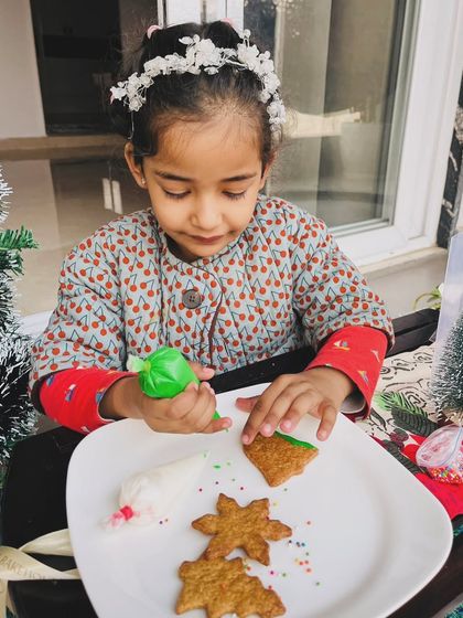 We love seeing little ones enjoying our DIY kits. Here's a young baker carefully decorating her gingerbread cookie.