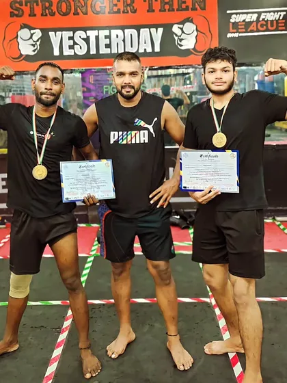 Two more champions holding their medals and certificates. The proof of our training is in the results.