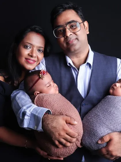 Capturing double the joy with a beautiful studio portrait of parents holding their newborn twins. I have experience posing and photographing twins to create cherished family keepsakes.
