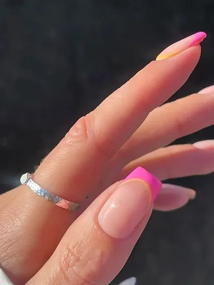 A side view of the pink and yellow abstract French manicure, showing the clean application and vibrant colors that make this design so eye-catching.