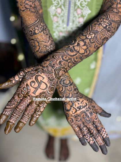 This design features the initials 'S' and 'F' on one palm and the name 'Saeed' in Arabic on the other.