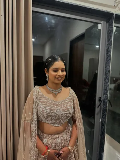 A soft and ethereal sangeet look. The makeup is minimal and glowing, paired with a simple hairstyle adorned with clips.