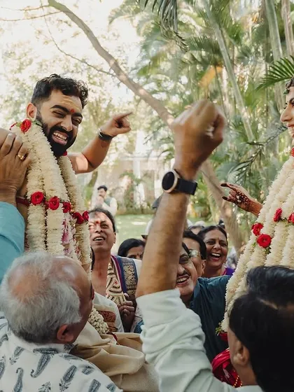 The joy of family is central to any wedding. This candid shot of the groom being lifted during the ceremony is full of laughter and celebration. I blend in with the crowd to make sure I never miss these precious, unscripted memories.