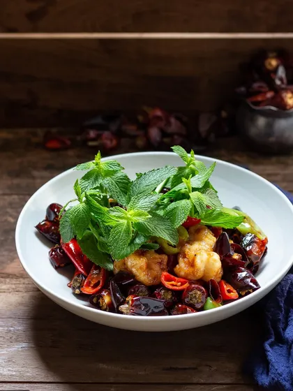 A spicy stir-fried fish dish with dried red chilies and fresh mint, another example from my earlier work.