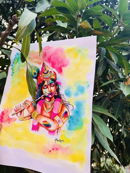A close-up of my Holi-special painting of Lord Krishna, held against a mango tree. The natural setting complements the colorful and festive mood of the artwork.