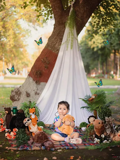 A sweet cuddle with a teddy bear during her park adventure. These outdoor sessions allow for beautiful, natural light and playful moments.