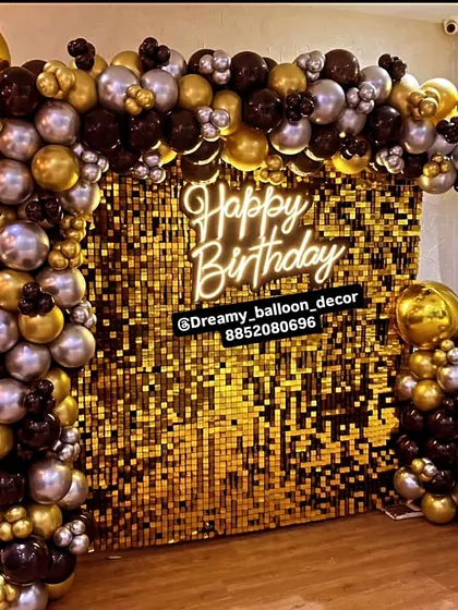 This is the kind of statement backdrop I love to create for birthdays and big celebrations. The combination of a gold sequin wall, a modern neon sign, and a full arch of black, gold, and silver balloons creates a truly glamorous photo corner for any event.