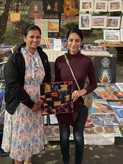 My wife with a happy customer who purchased her first abstract painting at Chitra Santhe. A proud moment for us!
