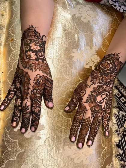 This design shows two different ways to personalize. One hand has a bold initial, while the other features a heart, both surrounded by beautiful patterns.