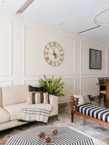 A comfortable, neutral-toned sofa is the perfect canvas for layering textures and patterns. Here, a mix of striped and woven cushions and a soft throw blanket make the seating area feel extra cozy and inviting.