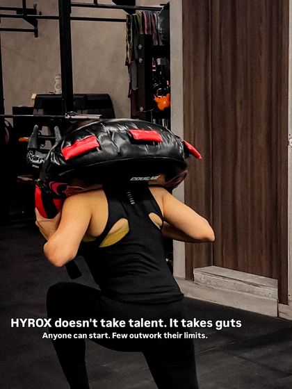 Guts over talent. This is the mindset we cultivate for Hyrox. Here, a member tackles sandbag lunges, showing the mental and physical toughness we build in our classes.