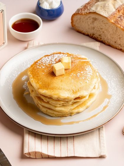 A perfect stack of my classic pancakes, topped with butter and ready for a drizzle of syrup. It’s a simple, timeless breakfast that I make with the utmost care.