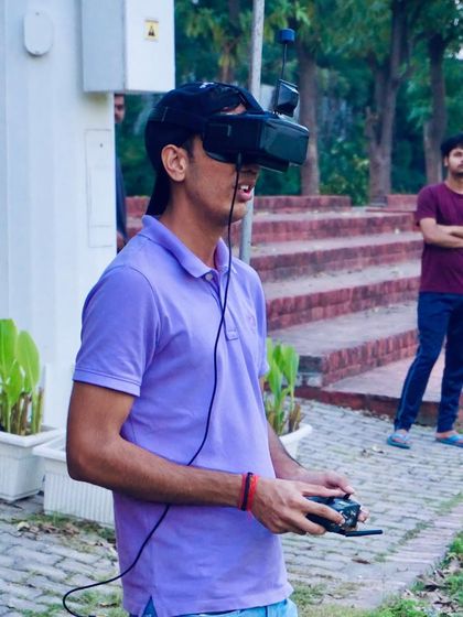 A student fully immersed in the FPV experience during one of our community flying meetups. These events are perfect for practicing skills in a supportive environment.