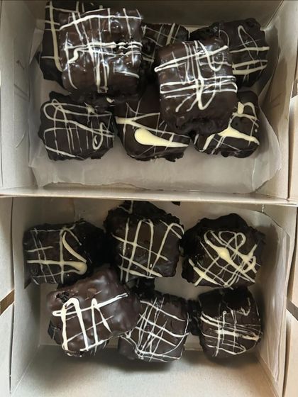 A close-up of my Double Chocolate Brownies packed in boxes. The white chocolate drizzle adds a beautiful contrast and extra flavor.