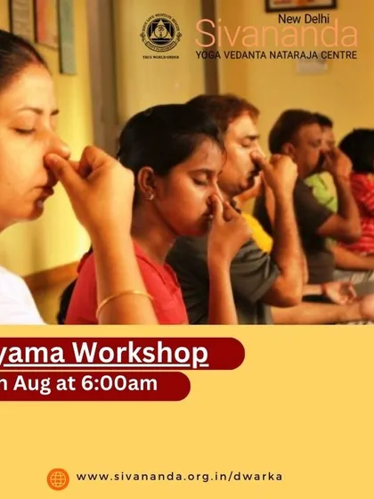 Students in a Pranayama workshop practicing Anulom Vilom, or alternate nostril breathing. This fundamental technique is taught to help balance the body's energies and calm the nervous system.