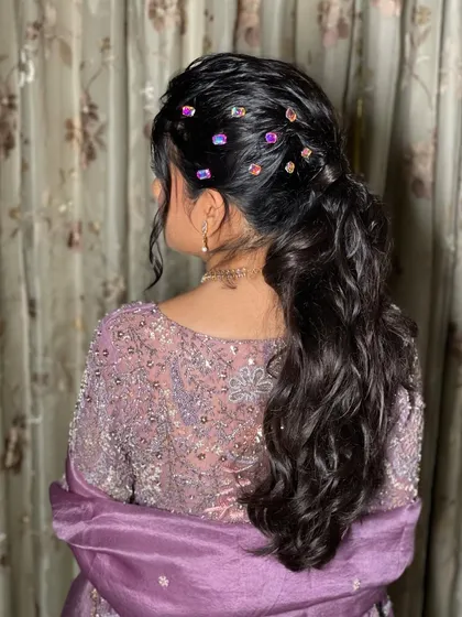 This messy, textured ponytail with crystal accessories is a modern and chic choice for any pre-wedding event. It's stylish, fun, and effortlessly glamorous.