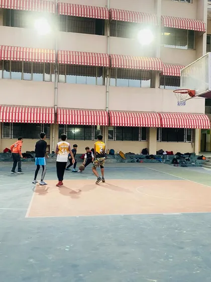 A senior player dribbles the ball up the court during a match.