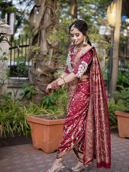 A side profile of the bride in her `Navari`, showing the unique drape and the elegance of the traditional attire.