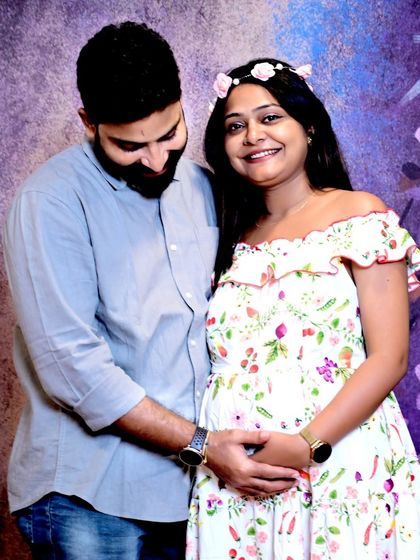 A joyful and candid shot of the happy couple. Their smiles and easy interaction show the excitement they share as they await their new arrival.