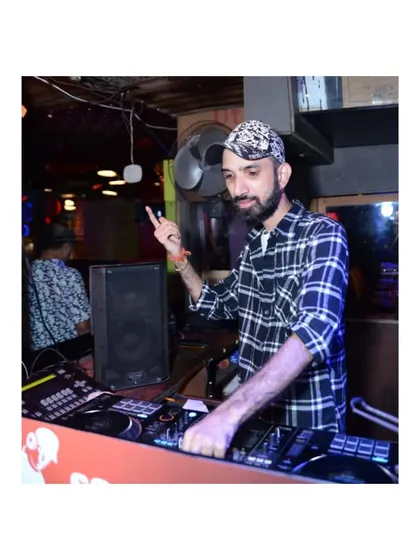 A shot of me pointing to the crowd, signaling a beat drop or calling for more energy. I am an interactive DJ who engages with the audience.