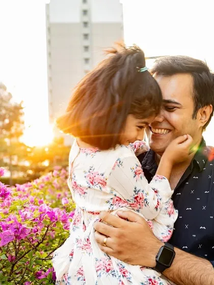 I love capturing the special connection between fathers and their daughters. This candid shot was taken during a beautiful sunset walk in a park. It's not posed, it's just a real, happy moment between them, full of smiles and affection.