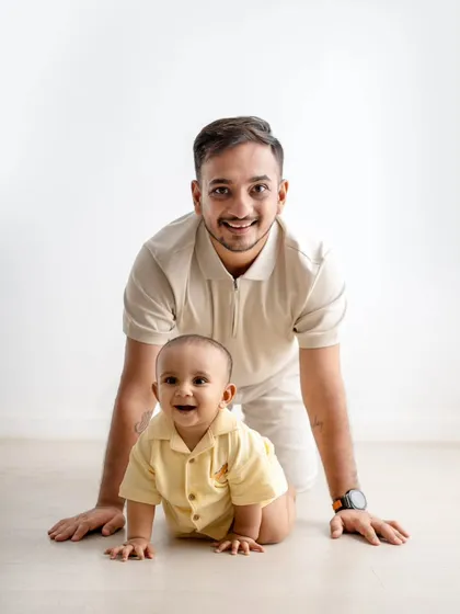 A proud dad with his one-year-old. I love capturing these one-on-one moments between parents and their children during our milestone sessions.