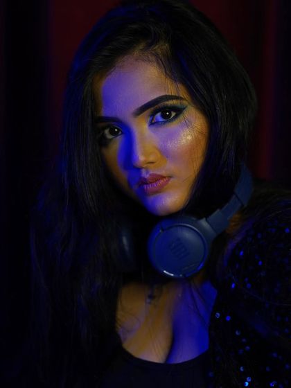 A close up portrait from a photoshoot. This is a glimpse of the person behind the console, focused and passionate about music.