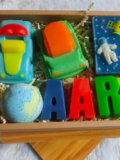 A closer view of the personalized "Aarav" hamper, showing the fun themes and bright colors.