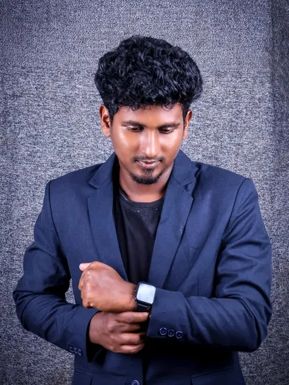 A classic "adjusting the watch" pose. This adds a touch of style and detail to the portrait, making it look candid and sophisticated.