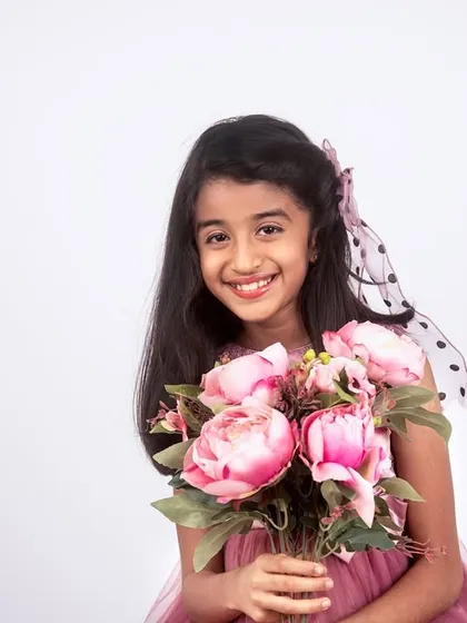 A classic studio portrait of a child. My style is clean and simple, focusing on your child's bright smile and personality against a crisp, white background.