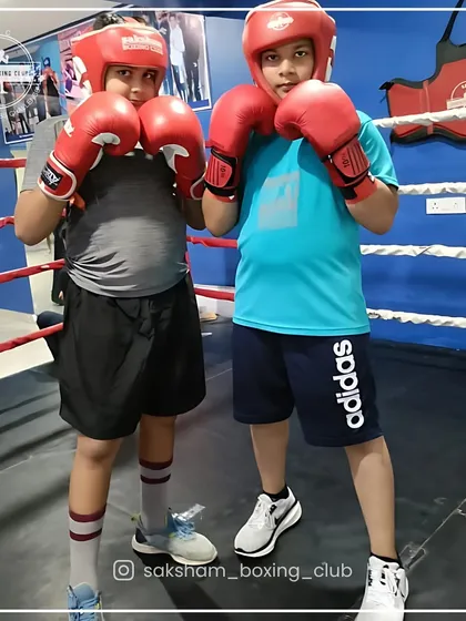 Two of my young champions geared up and ready in the ring. I ensure every child learns proper technique and safety from day one, building a solid foundation for their boxing journey.