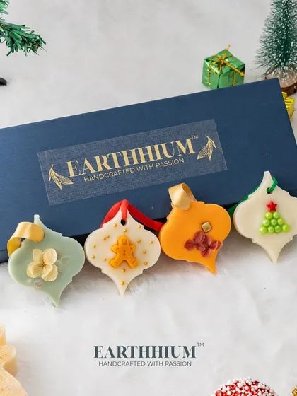 A set of four ornament-shaped Christmas wax sachets. Each one has a unique design, from a gingerbread man to a Christmas tree, making them a delightful festive decoration.