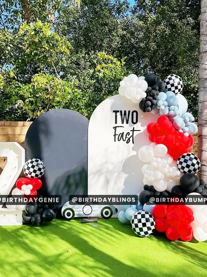 A "Two Fast" second birthday party with a modern, minimalist race car theme. The black, white, and red colors, along with a light-up number '2', create a chic and fun look.