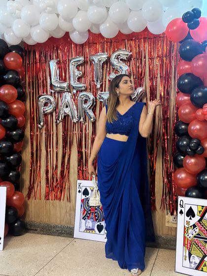 Posing with a playful vibe in this gorgeous blue saree. It's a versatile piece that can be dressed up or down depending on the event, making it a smart addition to any festive wardrobe.