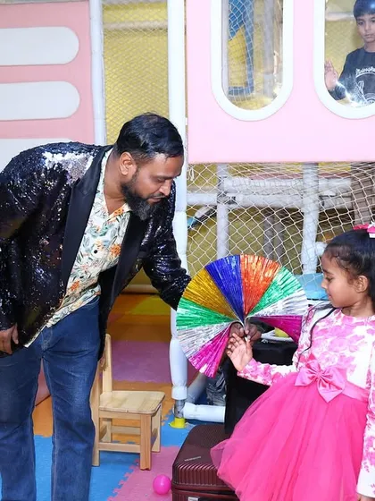 A magician performs a colorful trick for the birthday girl at her Peppa Pig party, adding an extra layer of fun and wonder to the day.