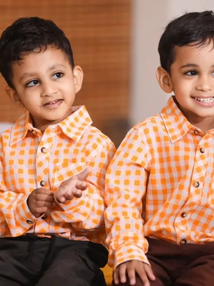 Double the smiles! A charming portrait of twin birthday boys in their matching outfits.