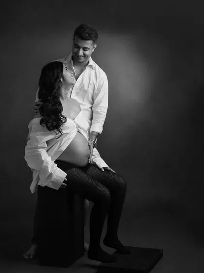A relaxed and intimate moment between a couple. The simple white shirt styling in this black and white photo creates a timeless, at-home feel even in the studio.