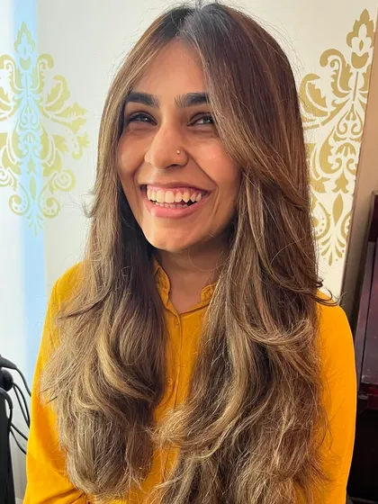Long hair doesn't have to be boring. By adding soft curtain bangs and strategic layers, I created a look for Roshni that has volume, movement, and a happy, lived-in feel.
