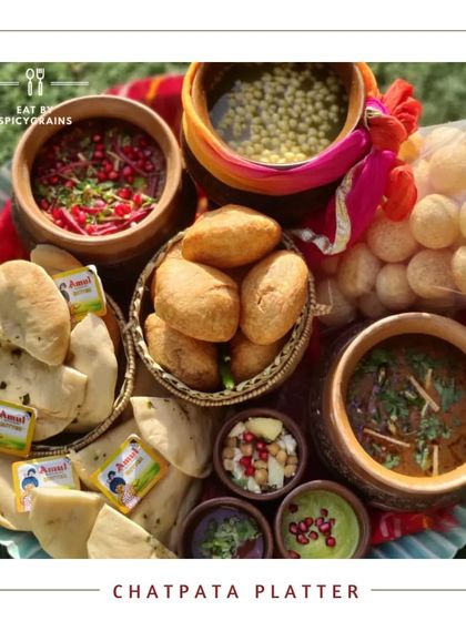 Our Chatpata Platter is a celebration of Indian street food, featuring golgappe, chole bhature, and dahi bhalla, all beautifully arranged.