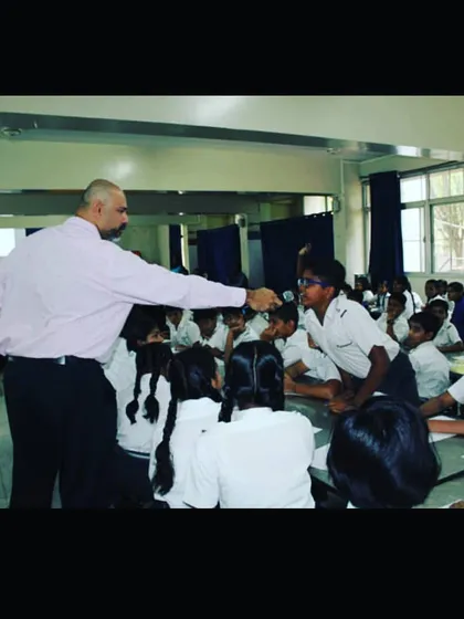 Personal attention is key. In this photo, I am working with a student during an interactive session. I make it a point to engage with each child, providing gentle corrections and encouragement to help them find their voice and build confidence.