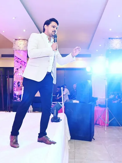 In action during an engagement ceremony. I use the stage to move around and connect with the audience from all angles.