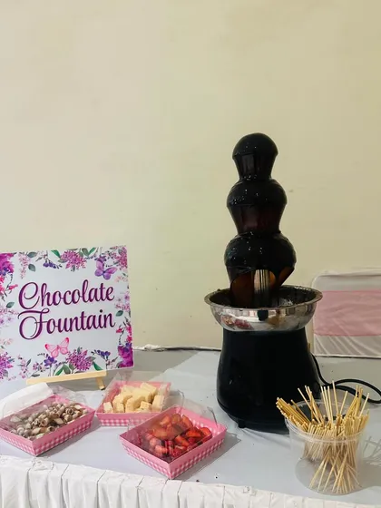 A full view of our chocolate fountain setup. We provide the fountain, a variety of dipping items like fruits and marshmallows, and all the necessary skewers.