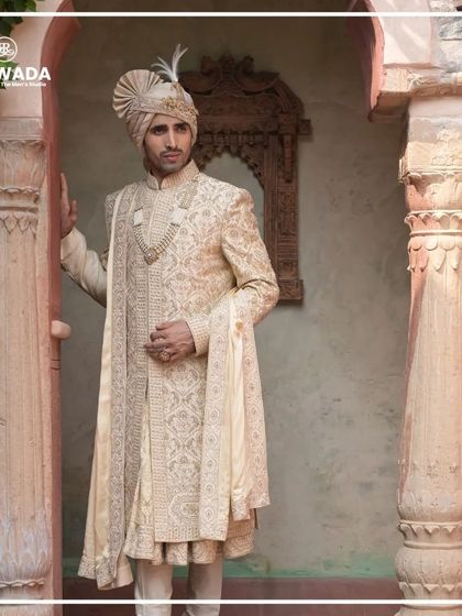 A groom in a Shauhar sherwani, framed by heritage architecture. The image showcases how my designs are inspired by and belong in such majestic settings.