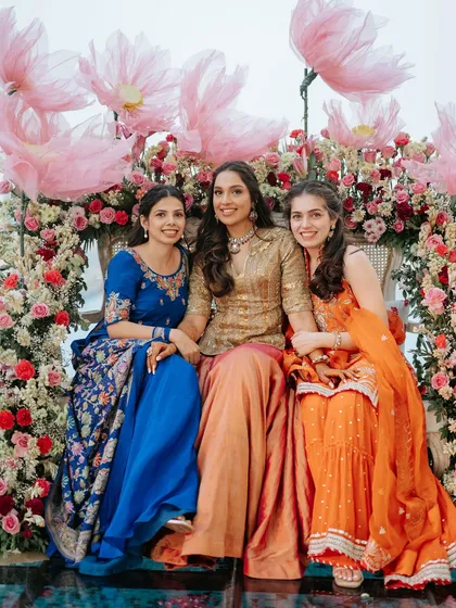 A vibrant group photo showcasing the beautiful traditional attire of the guests, which perfectly complements our decor.