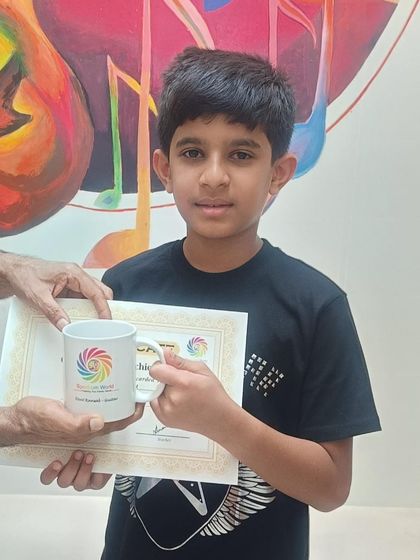 A close-up of Divit holding his certificate and gift. These moments of achievement and recognition are what make our teaching journey so rewarding.