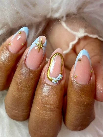 Elegance is in every single detail. This custom bridal set features baby blue French tips, gold studs, a celestial starburst, and a 3D gold frame with tiny flowers inside.