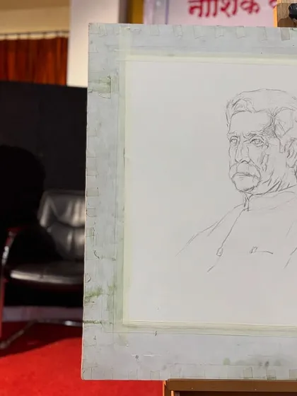 The initial pencil sketch on paper, with the model seated in the background. This foundational drawing is crucial for the proportions of the final watercolour portrait.
