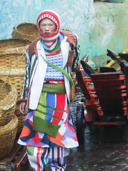 A moment of stillness amidst the chaos of the city. This shot from the "Kaleidoscope" series juxtaposes high-fashion knitwear with a raw, industrial background, creating a story of finding beauty in unexpected places.